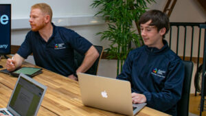 Two employees working together at desk
